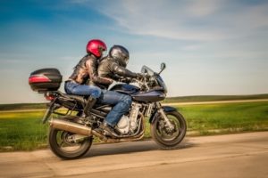 35423058 - couple bikers in a leather jacket riding a motorcycle on the road